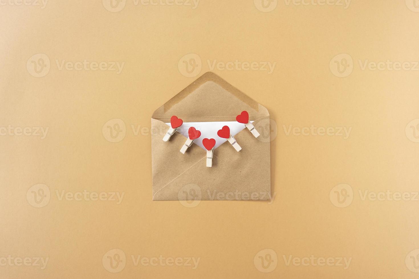 A brown envelope with red hearts in it for Valentines Day photo
