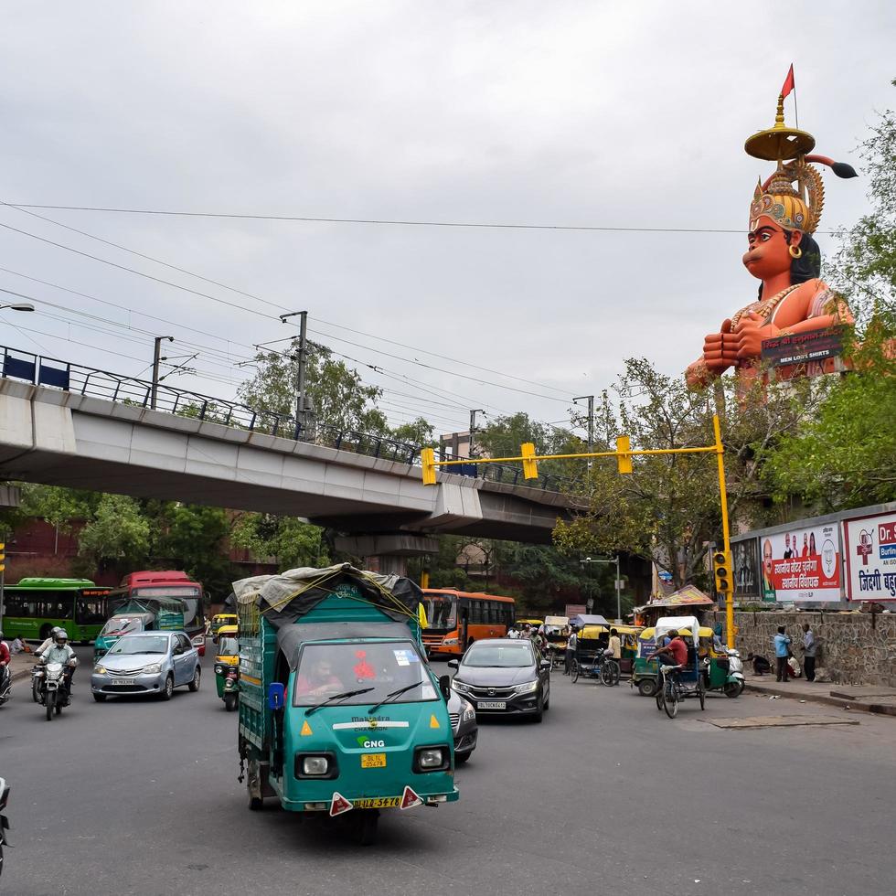 New Delhi, India - June 21, 2022 - Big statue of Lord Hanuman near the delhi metro bridge situated near Karol Bagh, Delhi, India, Lord Hanuman statue touching sky photo