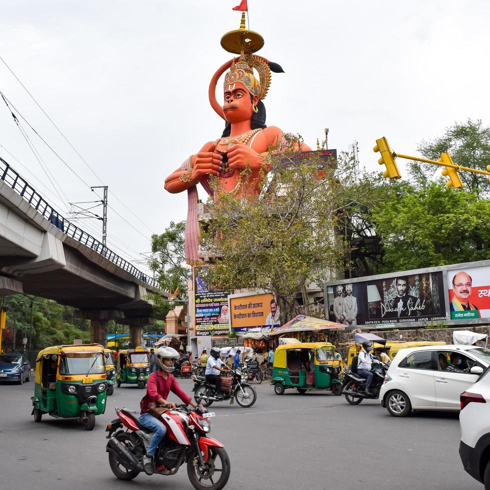 New Delhi, India - June 21, 2022 - Big statue of Lord Hanuman near the delhi metro bridge situated near Karol Bagh, Delhi, India, Lord Hanuman statue touching sky photo