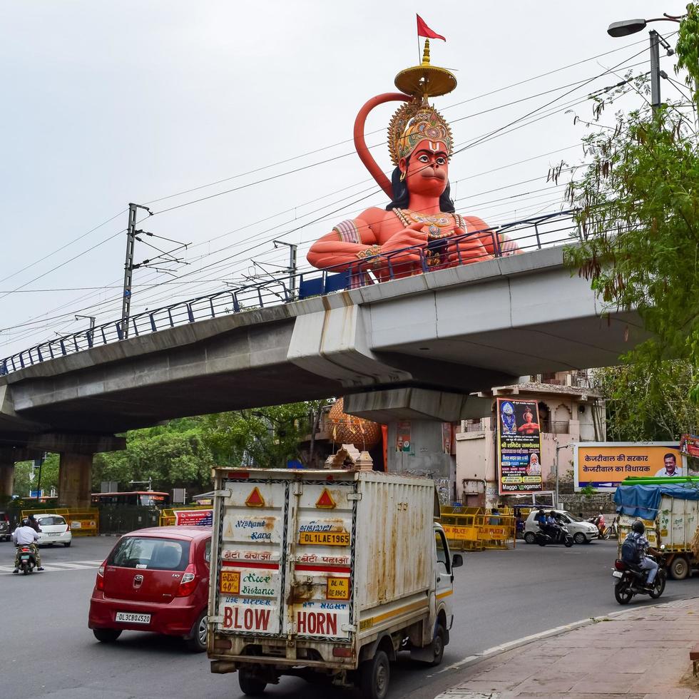 New Delhi, India - June 21, 2022 - Big statue of Lord Hanuman near the delhi metro bridge situated near Karol Bagh, Delhi, India, Lord Hanuman statue touching sky photo