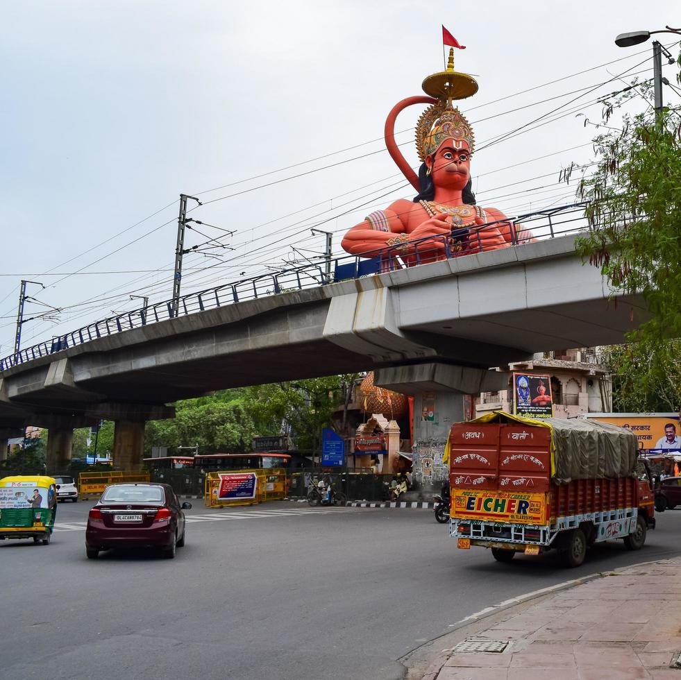 New Delhi, India - June 21, 2022 - Big statue of Lord Hanuman near the delhi metro bridge situated near Karol Bagh, Delhi, India, Lord Hanuman statue touching sky photo