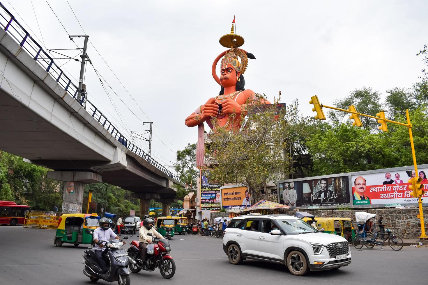 New Delhi, India - June 21, 2022 - Big statue of Lord Hanuman near the delhi metro bridge situated near Karol Bagh, Delhi, India, Lord Hanuman statue touching sky photo