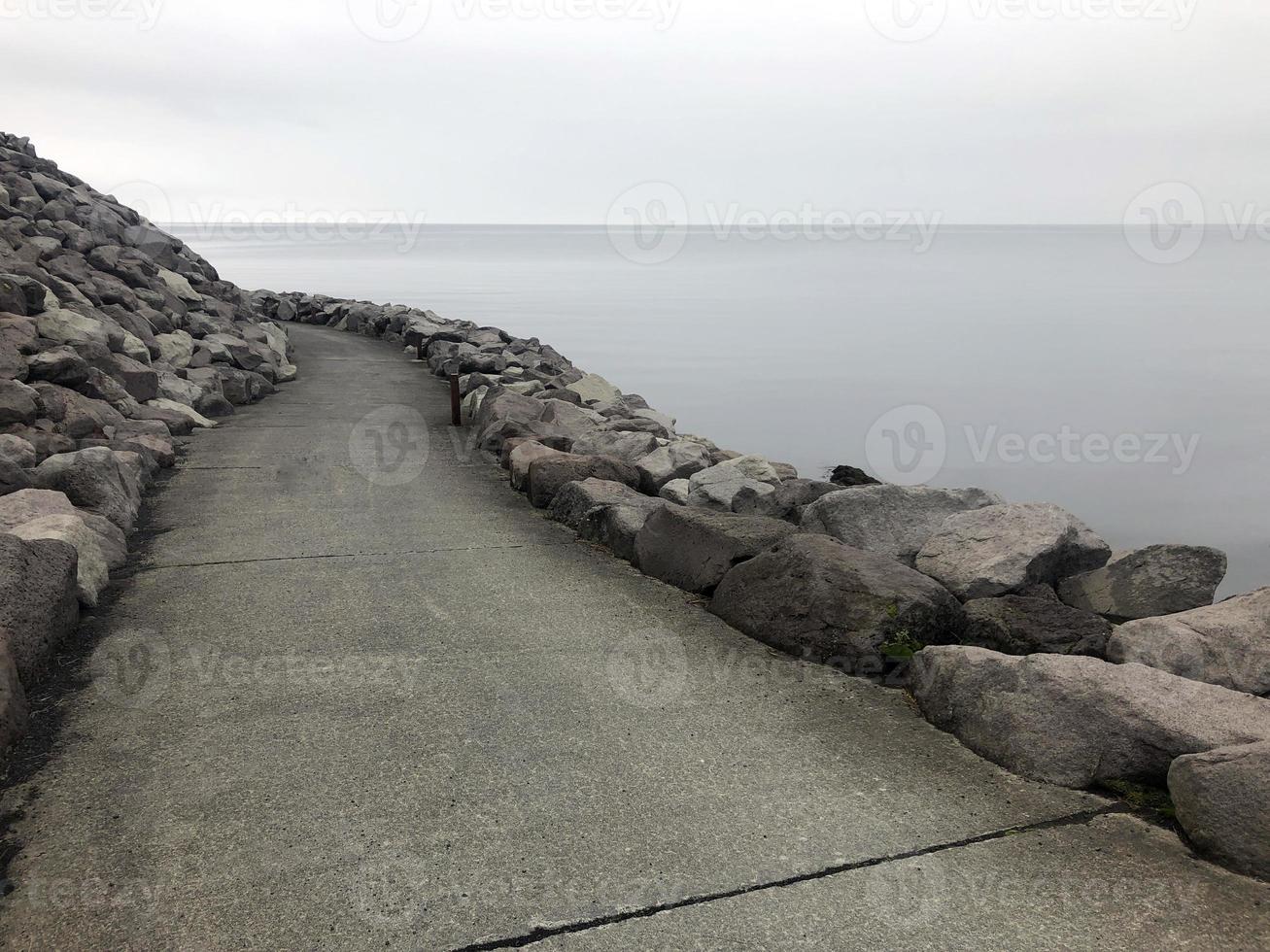 An empty path leading around a curve at the coast of Keflavik, Iceland photo