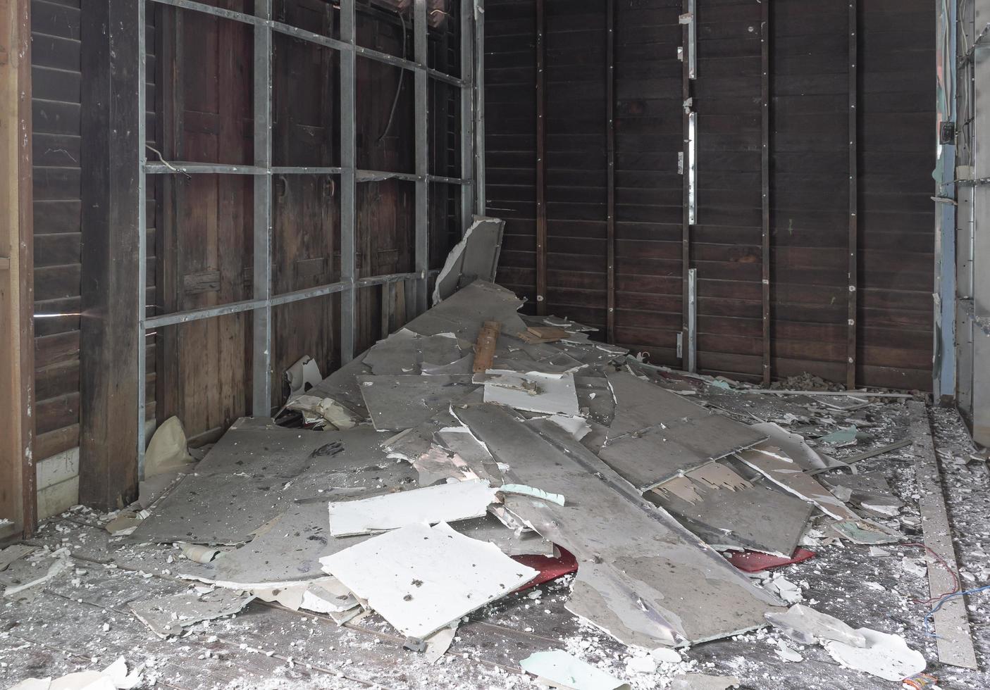 Wall demolition with scrap pile on floor photo