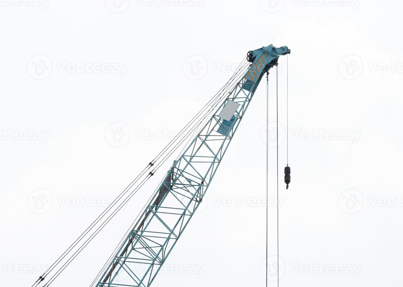 Large green crane boom with hooks with sky background photo