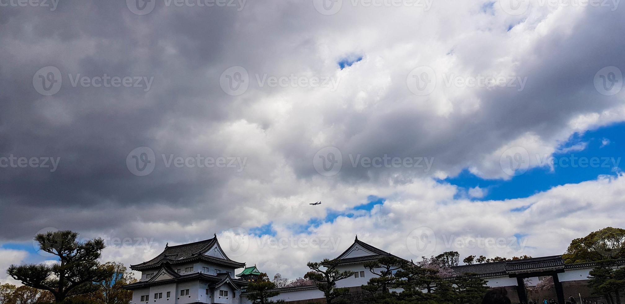 The surroundings of Osaka Castle in spring season with beautiful sky, calm river and cherry blossom. photo