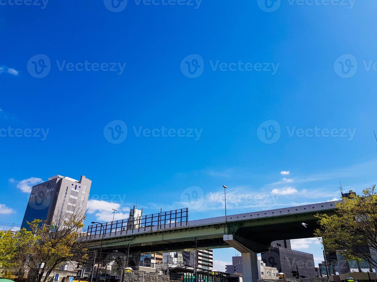 The side view of an overpass bridge in Osaka, shows a girder made of high tensile steel in green and gray. photo