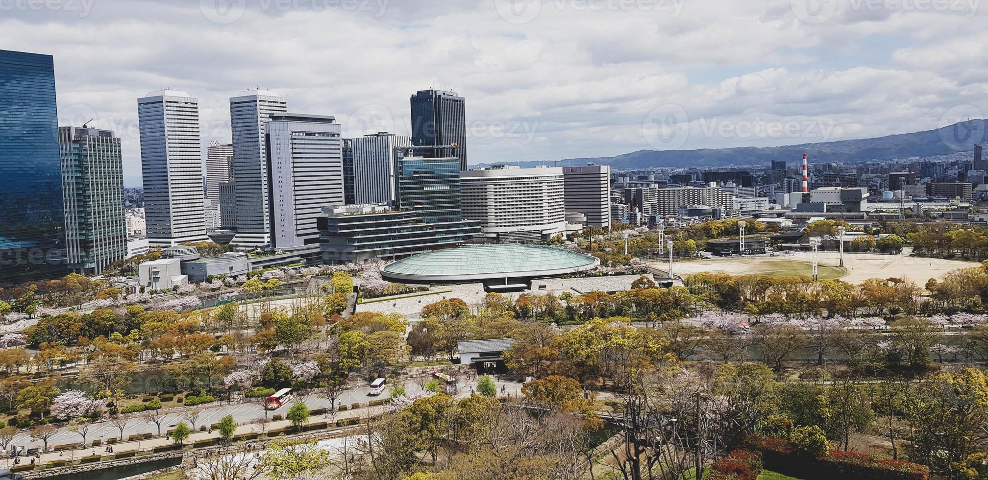 View from the roof of Osaka Castle as seen from the roof with scenery of Osaka skyscrapers in Osaka City and the park around the Castle photo