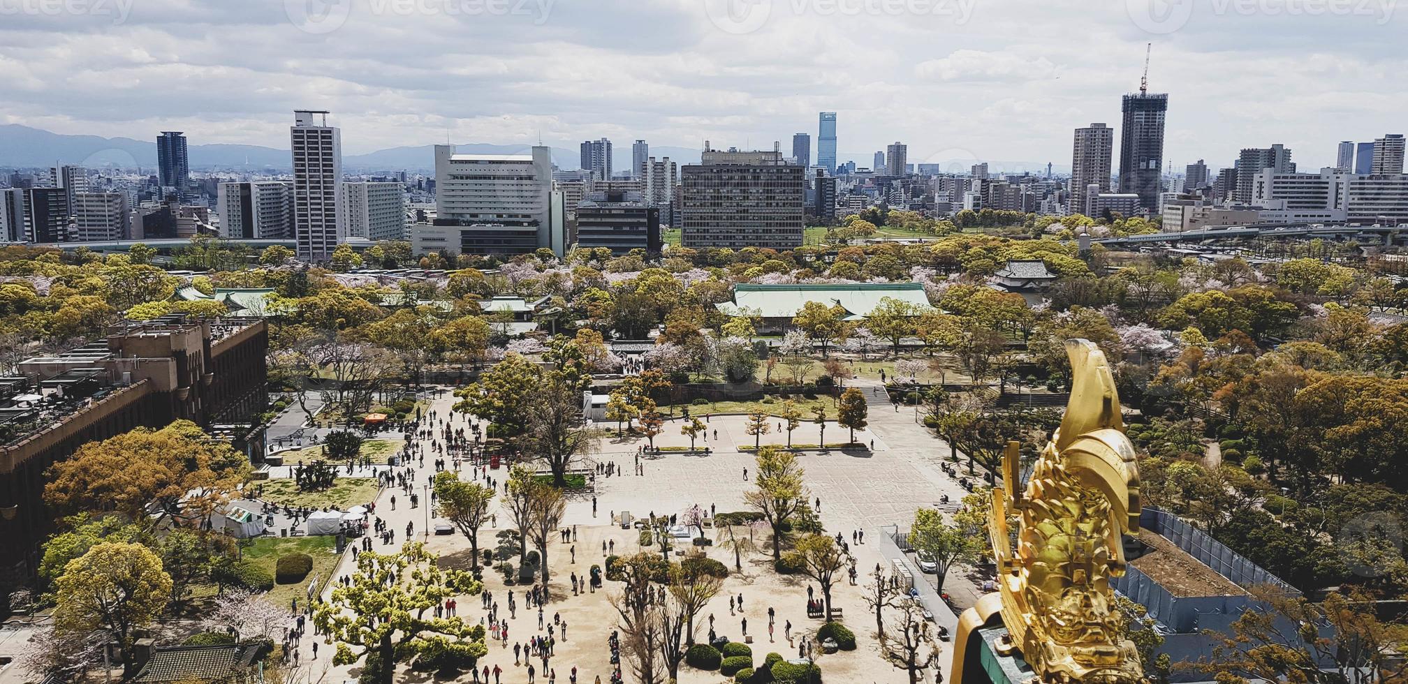 South view from Osaka Castle as seen from the roof that is decorating by the golden fish, with scenery of Osaka skyscrapers in Osaka City photo