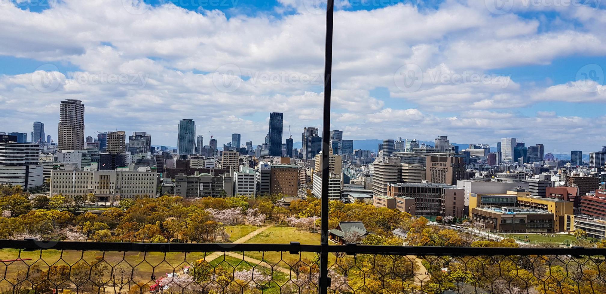 South view from Osaka Castle as seen from the roof that is decorating by the golden fish, with scenery of Osaka skyscrapers in Osaka City photo