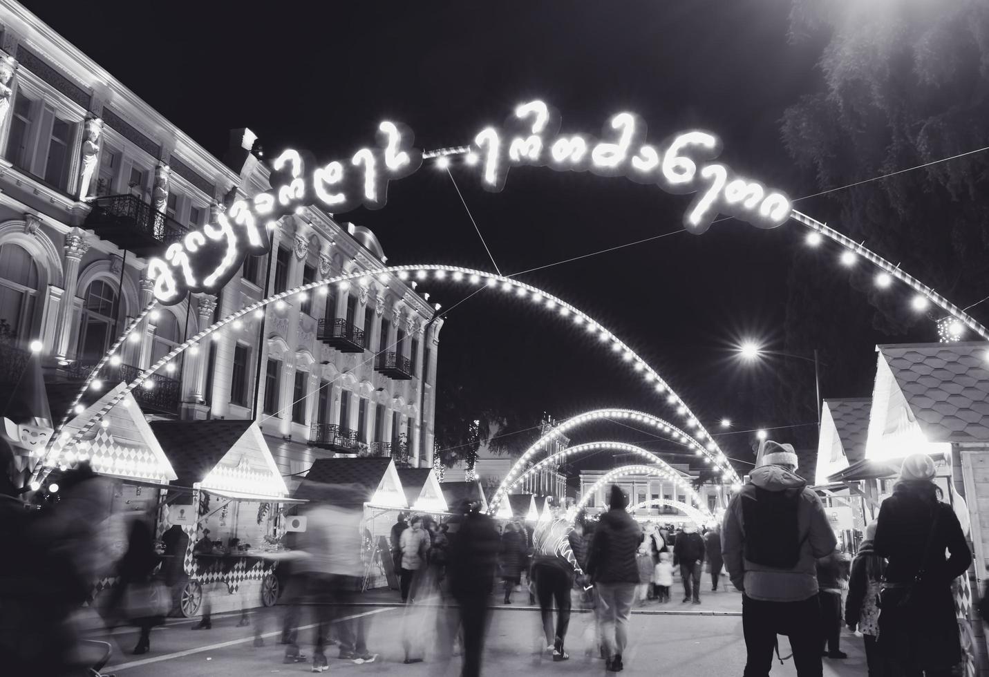 Tbilisi, Georgia, 2021 - street view crowds of people with children on xmas market on Christmas day. Celebrations and city holidays spirit photo