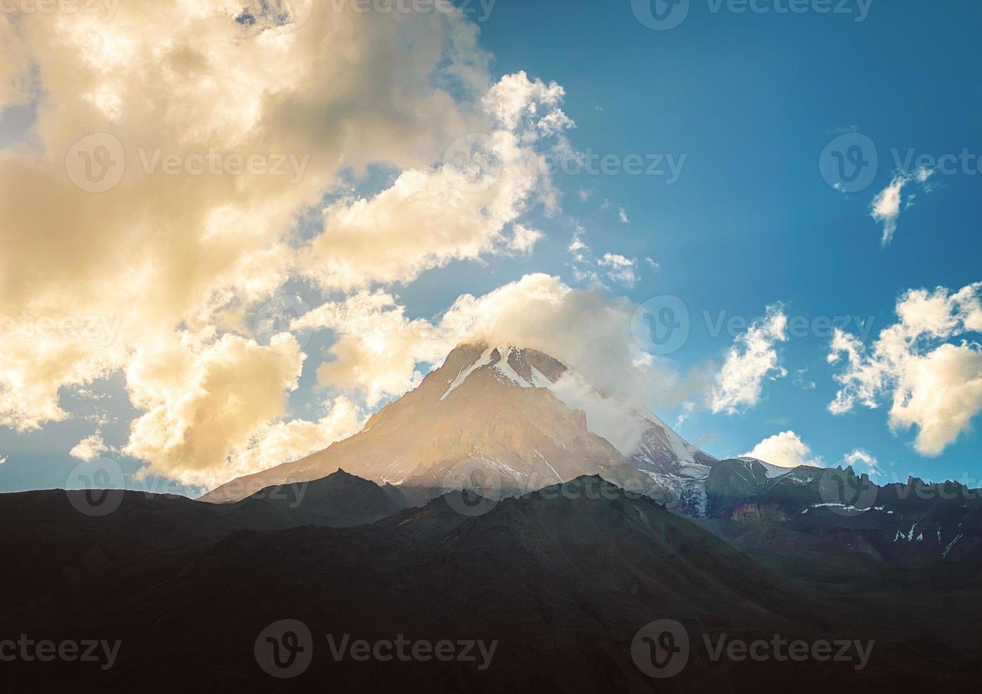 . Peak Of Mount Kazbek Covered With Snow. Kazbek Is A Stratovolcano And One Of Major Mountains Of Caucasus. Beautiful Georgia Nature Landscape In Early Winter. Gergeti glacier photo