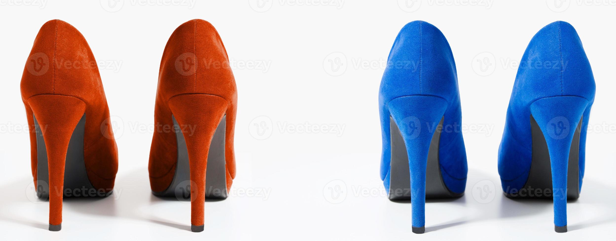 Closeup of fashionable high heels red and blue shoes isolated on white background. Blue color woman shoe on floor. Shopping and fashion concept. Copy space. Selective focus photo