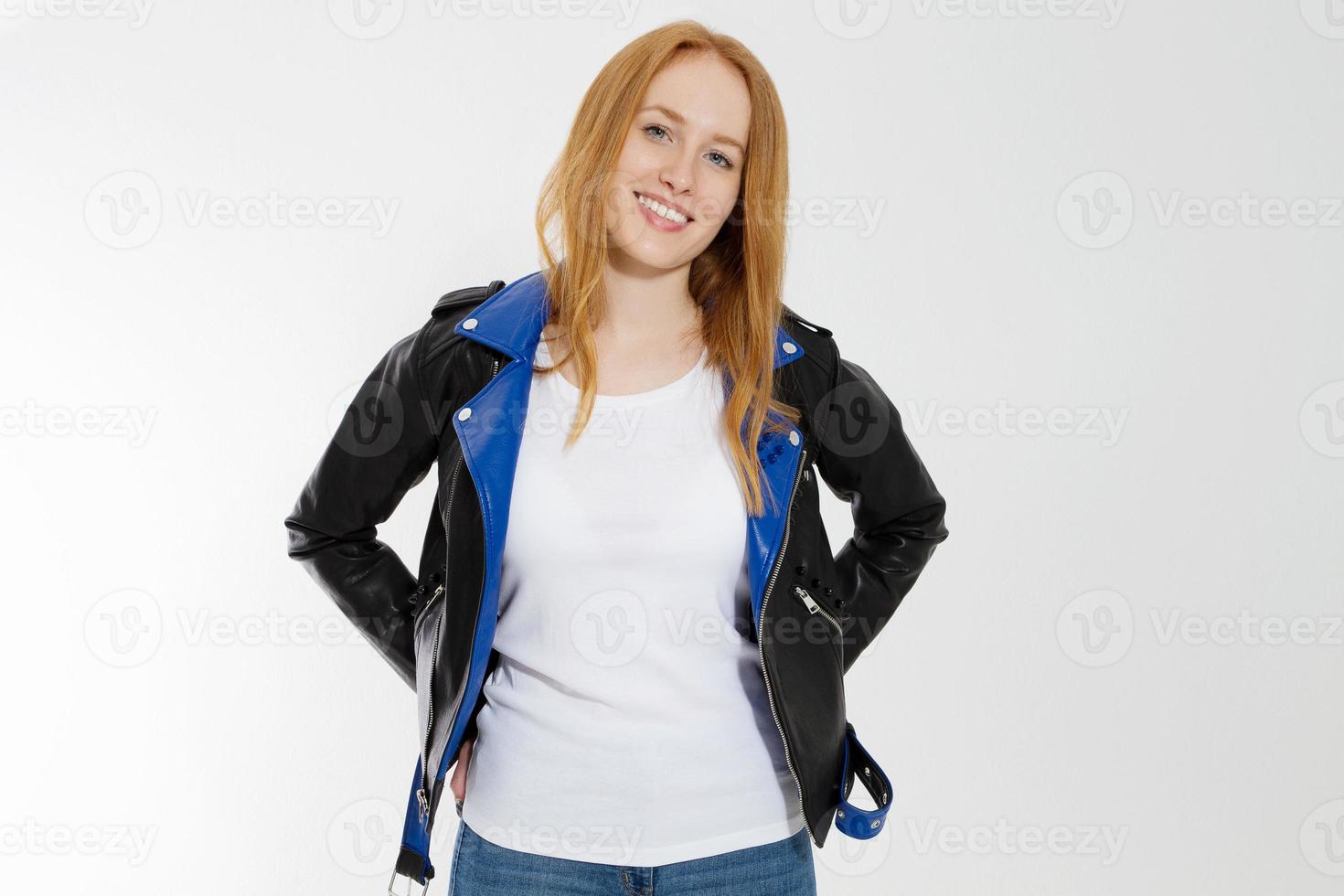 Woman in white t shirt and black leather jacket isolated on white background. Red hair girl in fashion clothes front view. Blank template summer t-shirt. Copy space photo