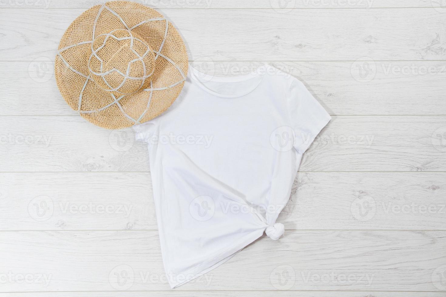 White closeup t shirt mock up flat lay on white wooden background. Top view and copy space. Mockup summer t-shirt and summertime. Template blank shirt. photo