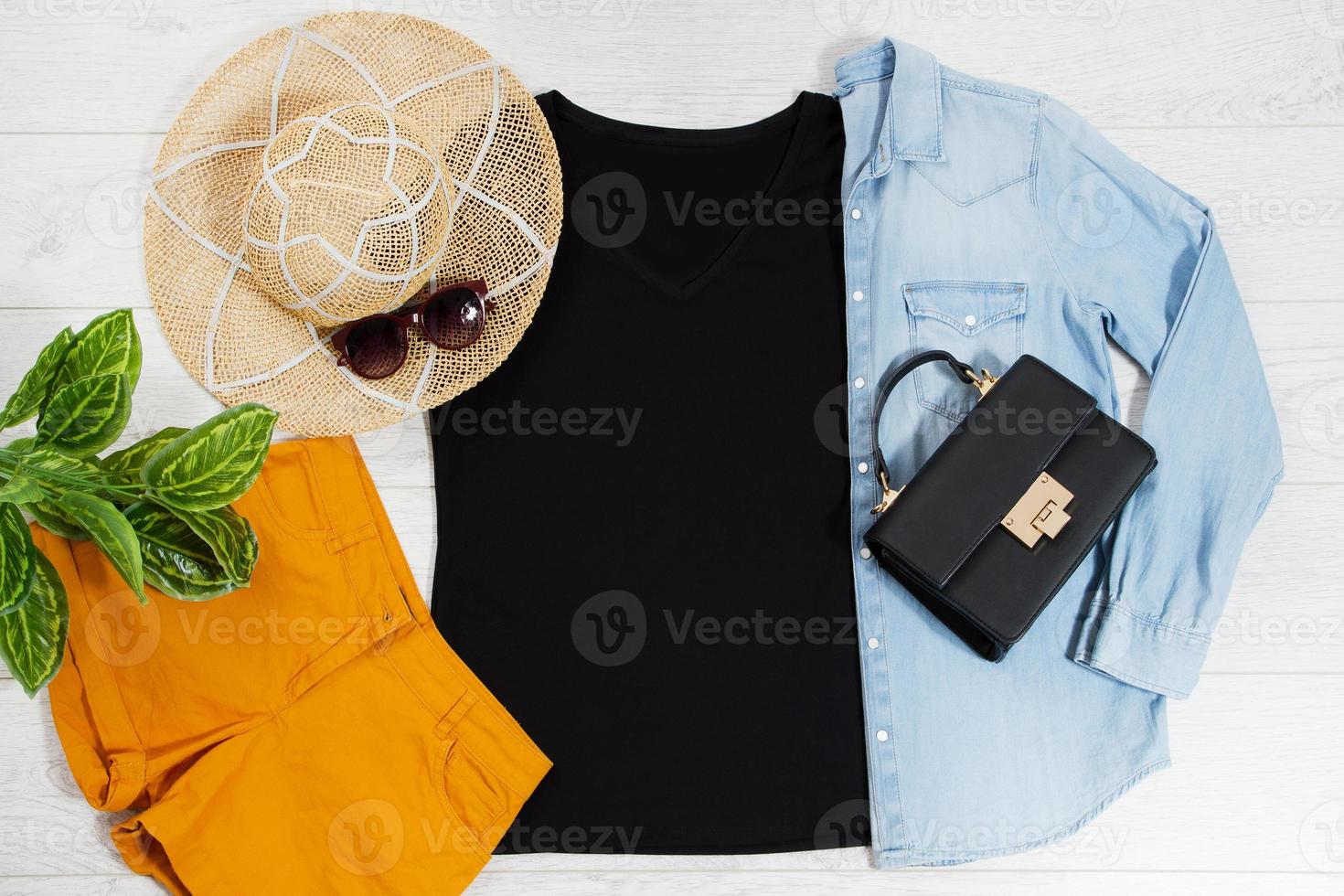 T shirt black. T-shirt Mockup flat lay with summer accessories. Hat, bag and sunglasses on wooden floor background. Copy space. Template blank canvas. Front top view. photo