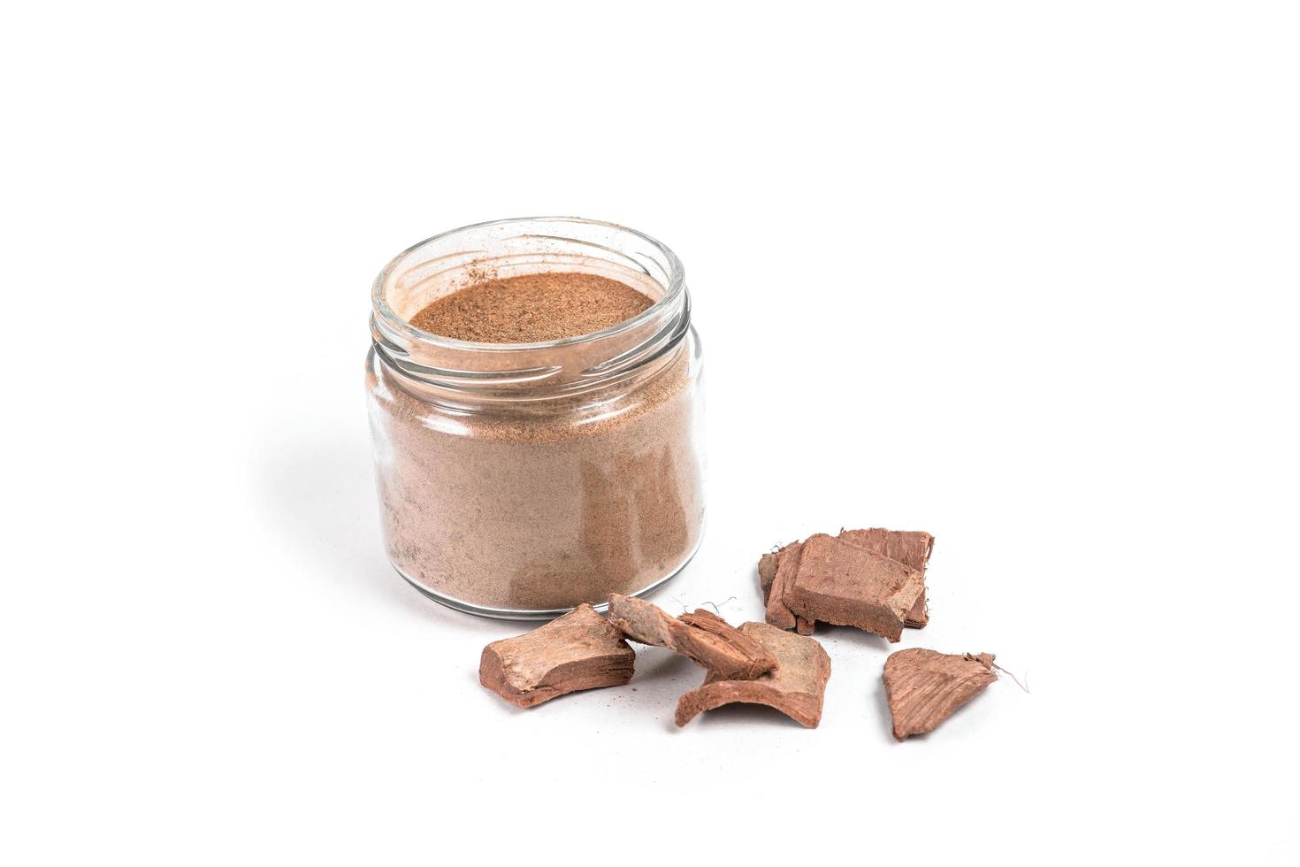 Dry arjun chal powder or Terminalia arjuna ayurvedic herb on white background photo