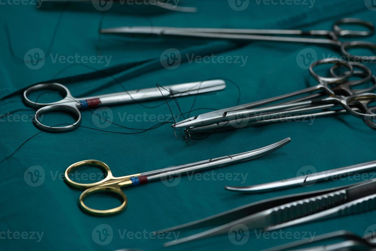 Surgical instruments on green table photo