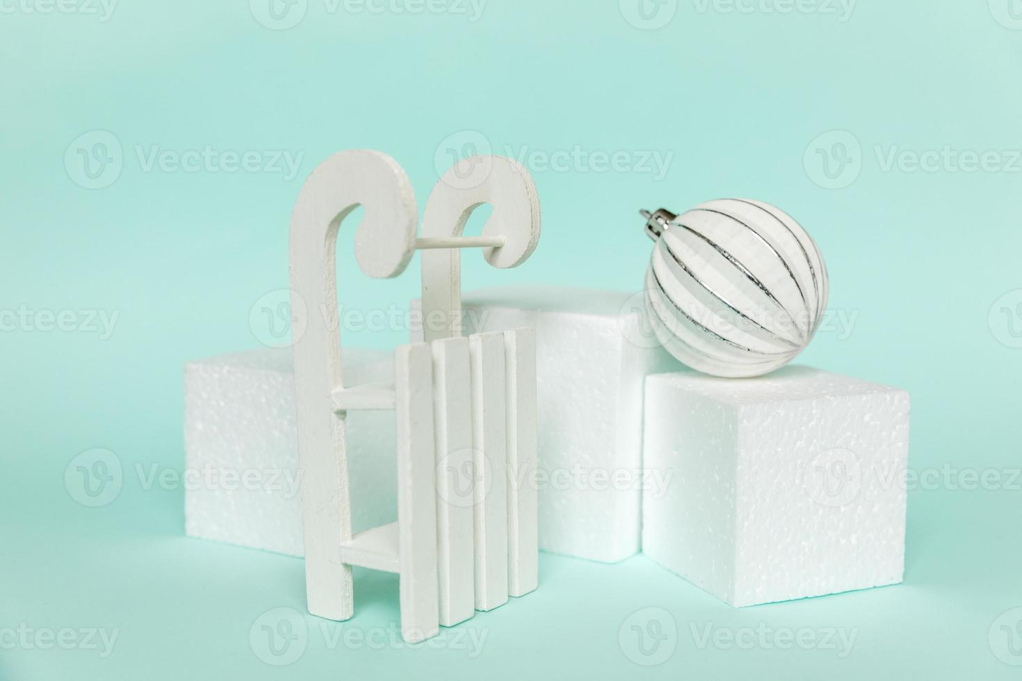 Simply minimal composition winter objects ornament and cube shapes geometric form podium isolated blue pastel background. Christmas New Year december time for celebration concept. Mockup, copy space photo