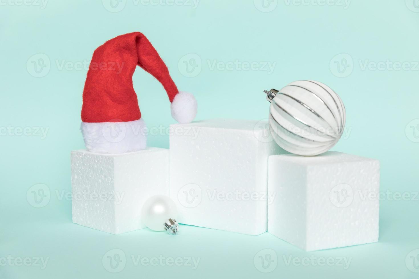 Simply minimal composition winter objects ornament and cube shapes geometric form podium isolated blue pastel background. Christmas New Year december time for celebration concept. Mockup, copy space photo