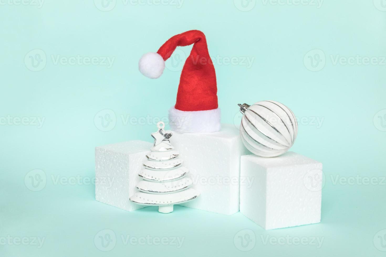 Simply minimal composition winter objects ornament and cube shapes geometric form podium isolated blue pastel background. Christmas New Year december time for celebration concept. Mockup, copy space photo