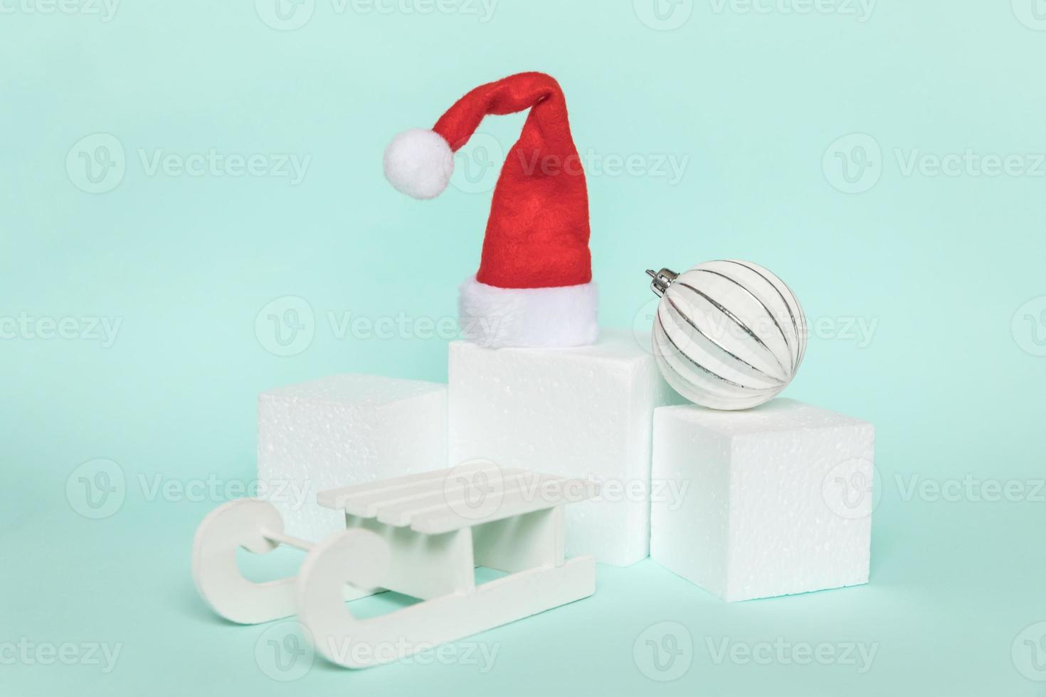 Simply minimal composition winter objects ornament and cube shapes geometric form podium isolated blue pastel background. Christmas New Year december time for celebration concept. Mockup, copy space photo