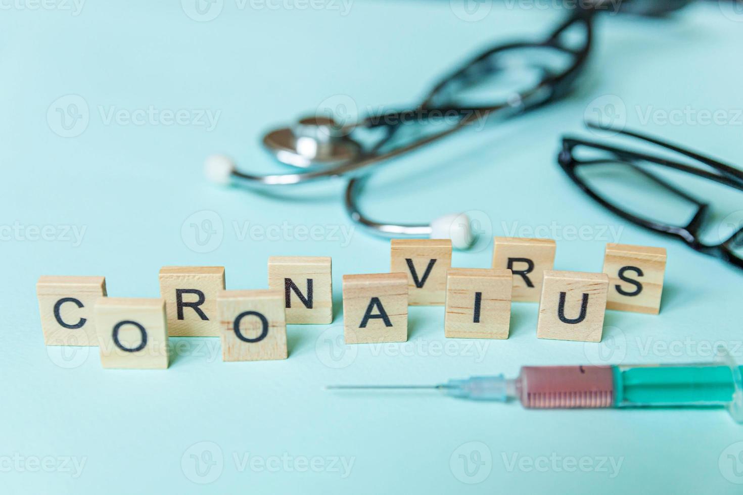 Text phrase Coronavirus syringe eyeglasses and stethoscope on blue pastel background. Novel coronavirus 2019-nCoV MERS-Cov covid-19 middle East respiratory syndrome coronavirus virus vaccine concept. photo