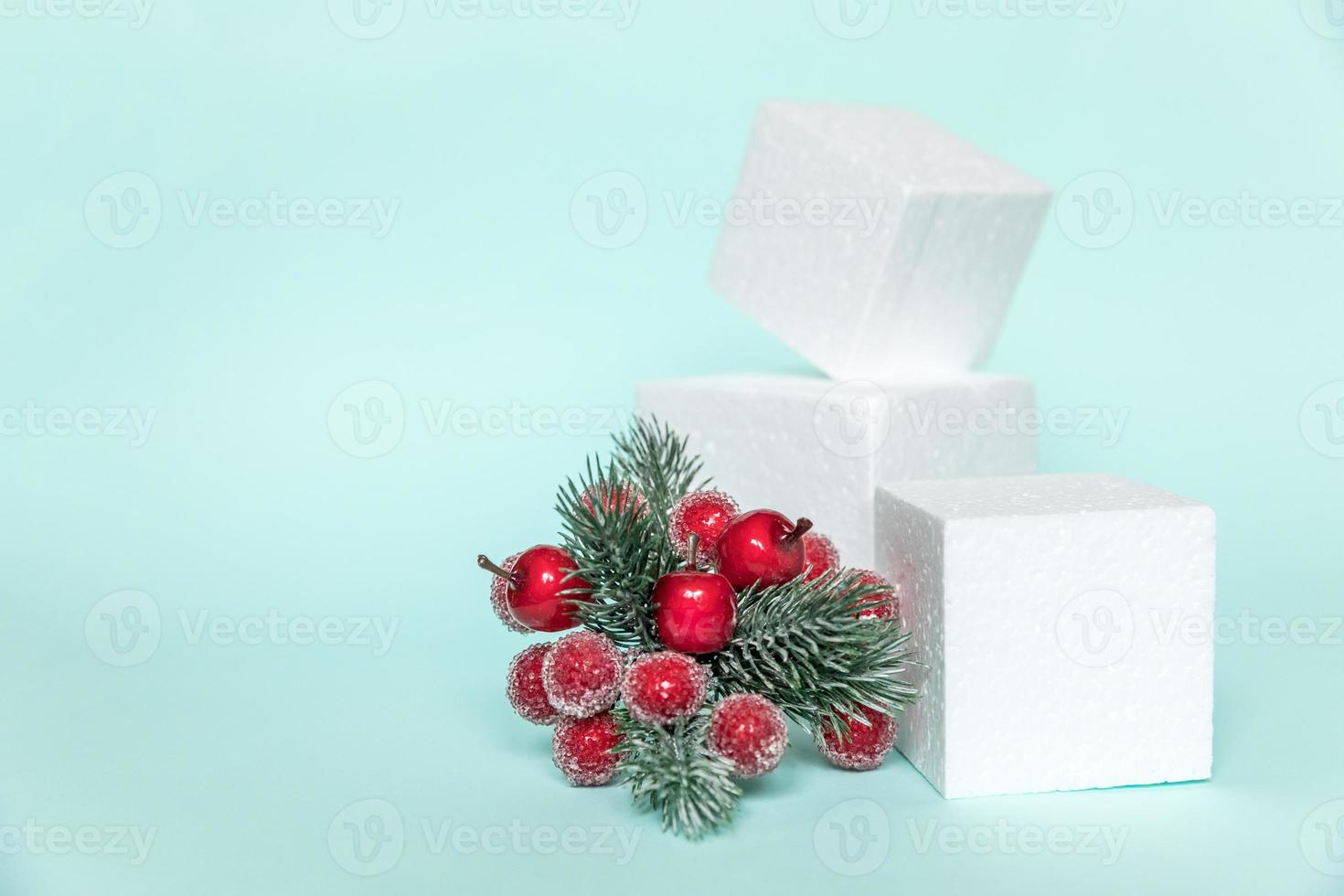Simply minimal composition winter objects ornament and cube shapes geometric form podium isolated blue pastel background. Christmas New Year december time for celebration concept. Mockup, copy space photo