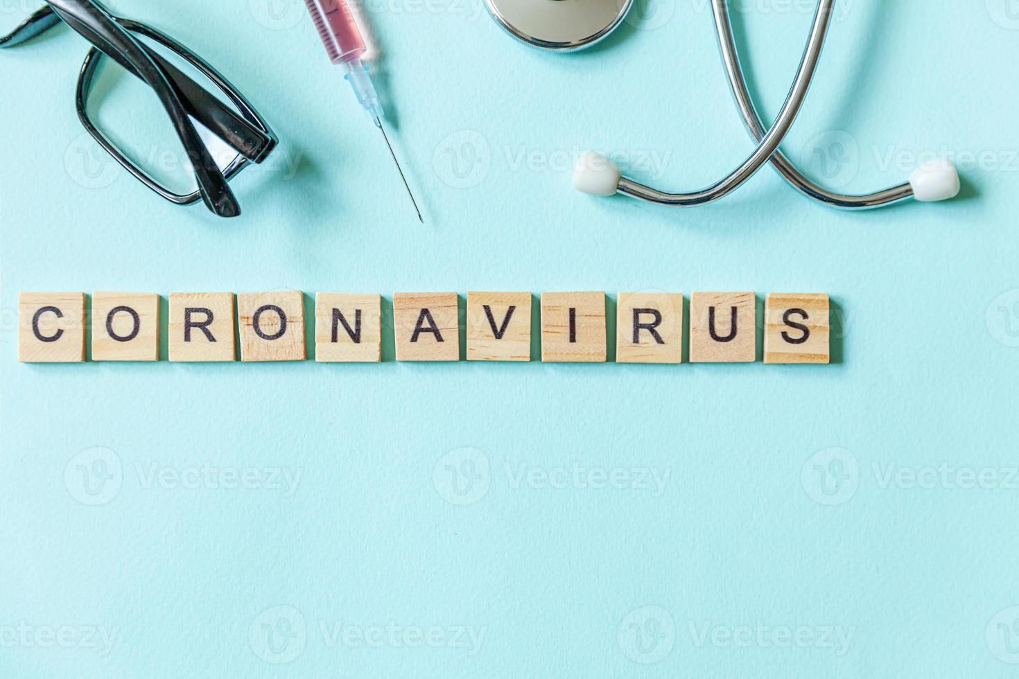 Text phrase Coronavirus syringe eyeglasses and stethoscope on blue pastel background. Novel coronavirus 2019-nCoV MERS-Cov covid-19 middle East respiratory syndrome coronavirus virus vaccine concept. photo