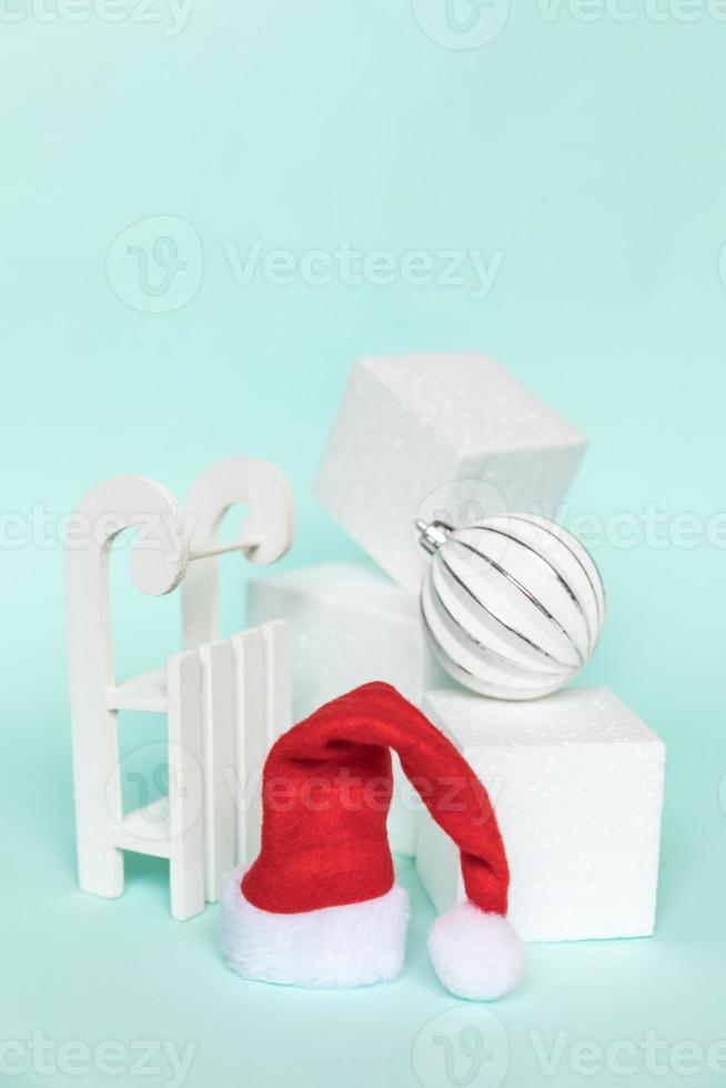 Simply minimal composition winter objects ornament and cube shapes geometric form podium isolated blue pastel background. Christmas New Year december time for celebration concept. Mockup, copy space photo