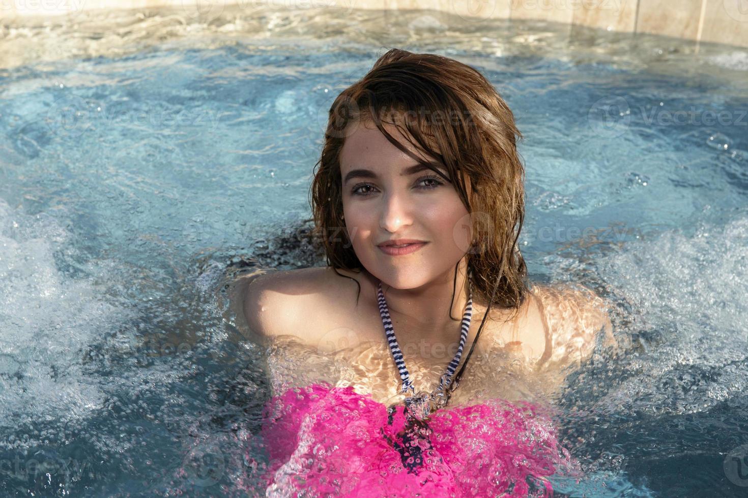 smiling black hair mexican latina girl portrait in Jacuzzi photo