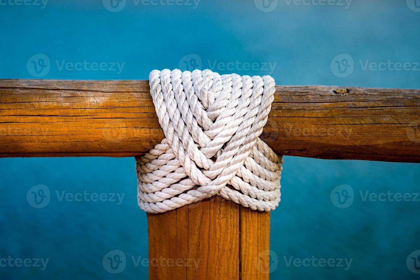 white rope wood cross on blue photo