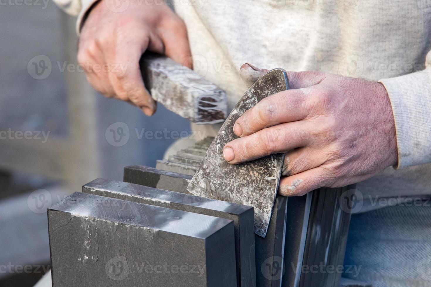 Old retired man hands working slate photo