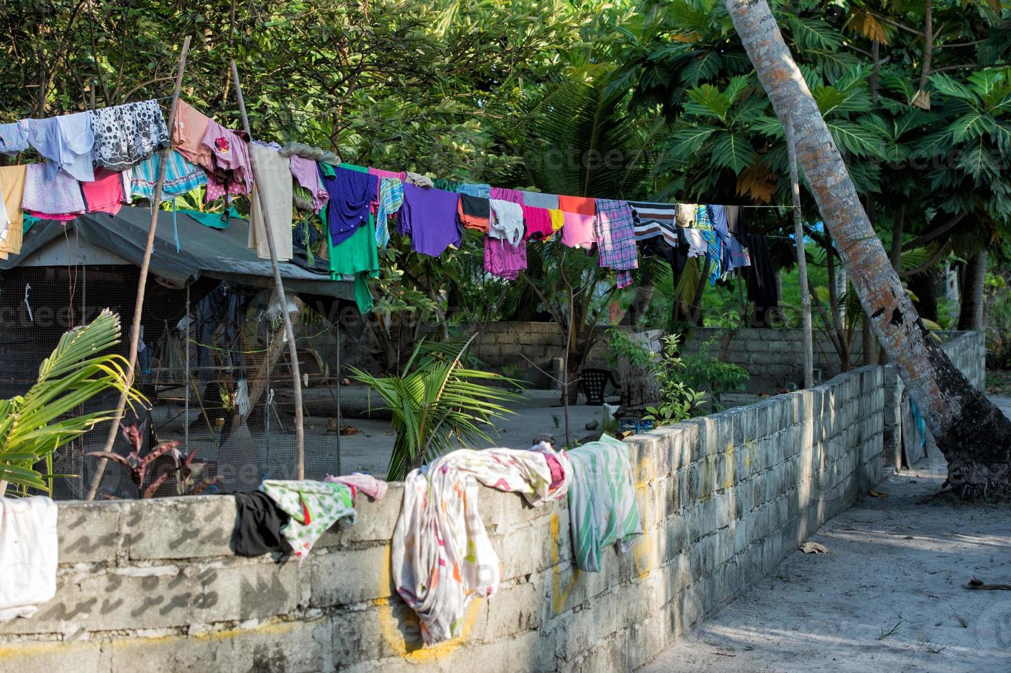 dress driying outside poor hovel, shanty, shack photo