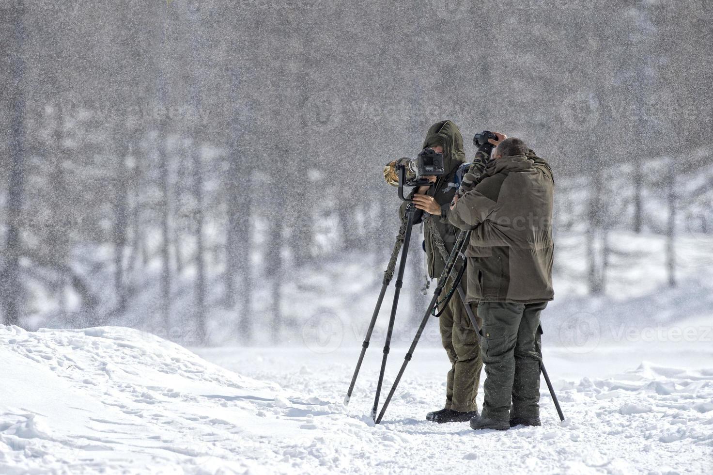 photographers under the snow storm in muntain photo