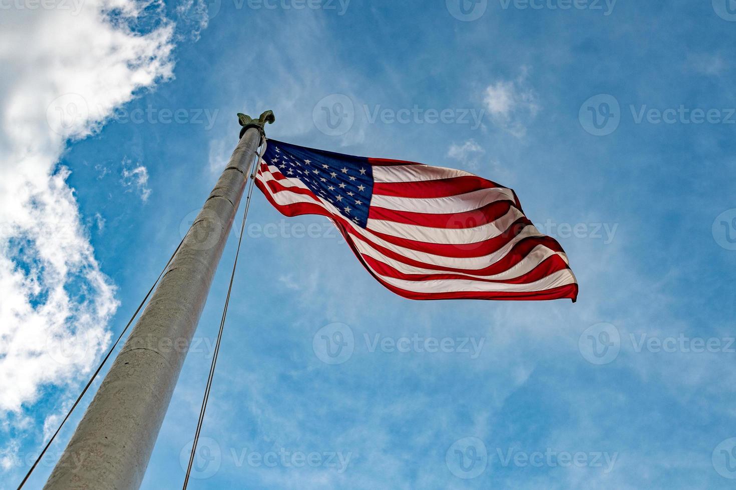 Giant Usa American flag stars and stripes on sky background photo
