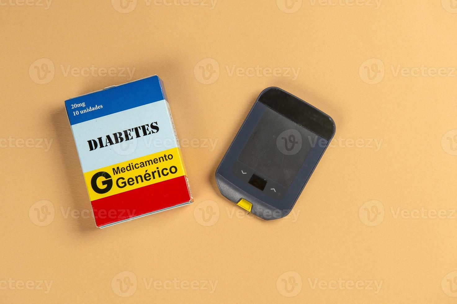 Fake medicine box with the name of the disease Diabetes and a glucometer. photo