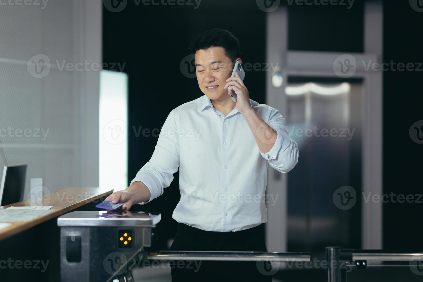 The worker enters the office, opens the door with an electronic key with a card photo