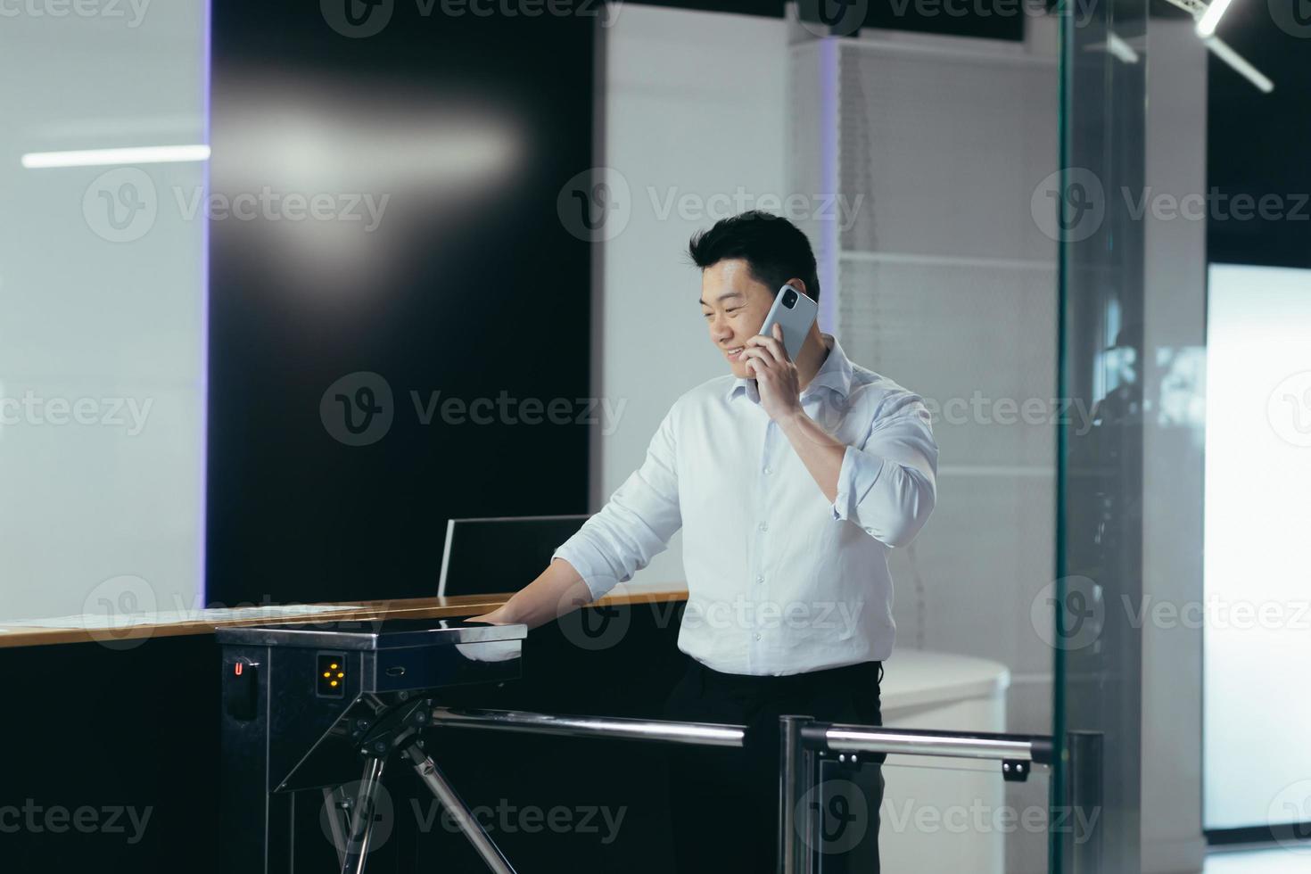 The worker enters the office, opens the door with an electronic key with a card photo