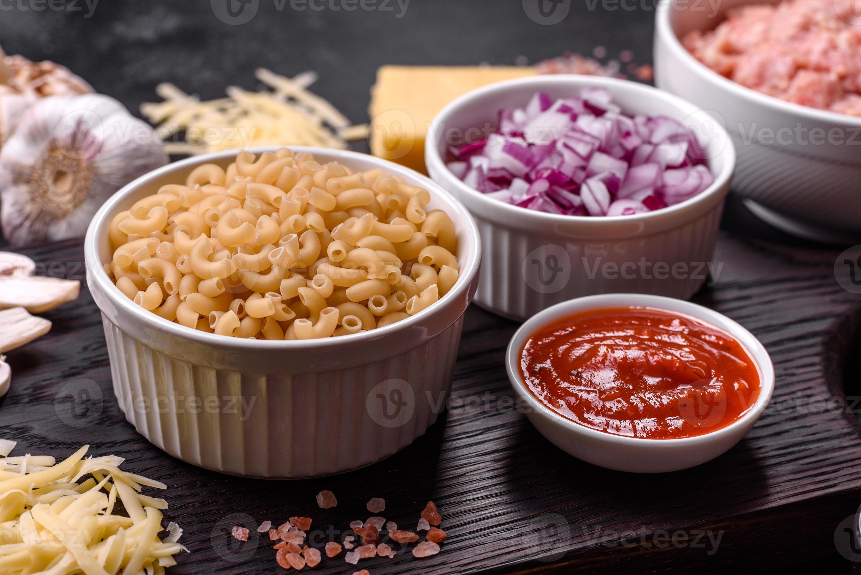 Raw pasta, mushrooms, onions, mince, spices and herbs to make a