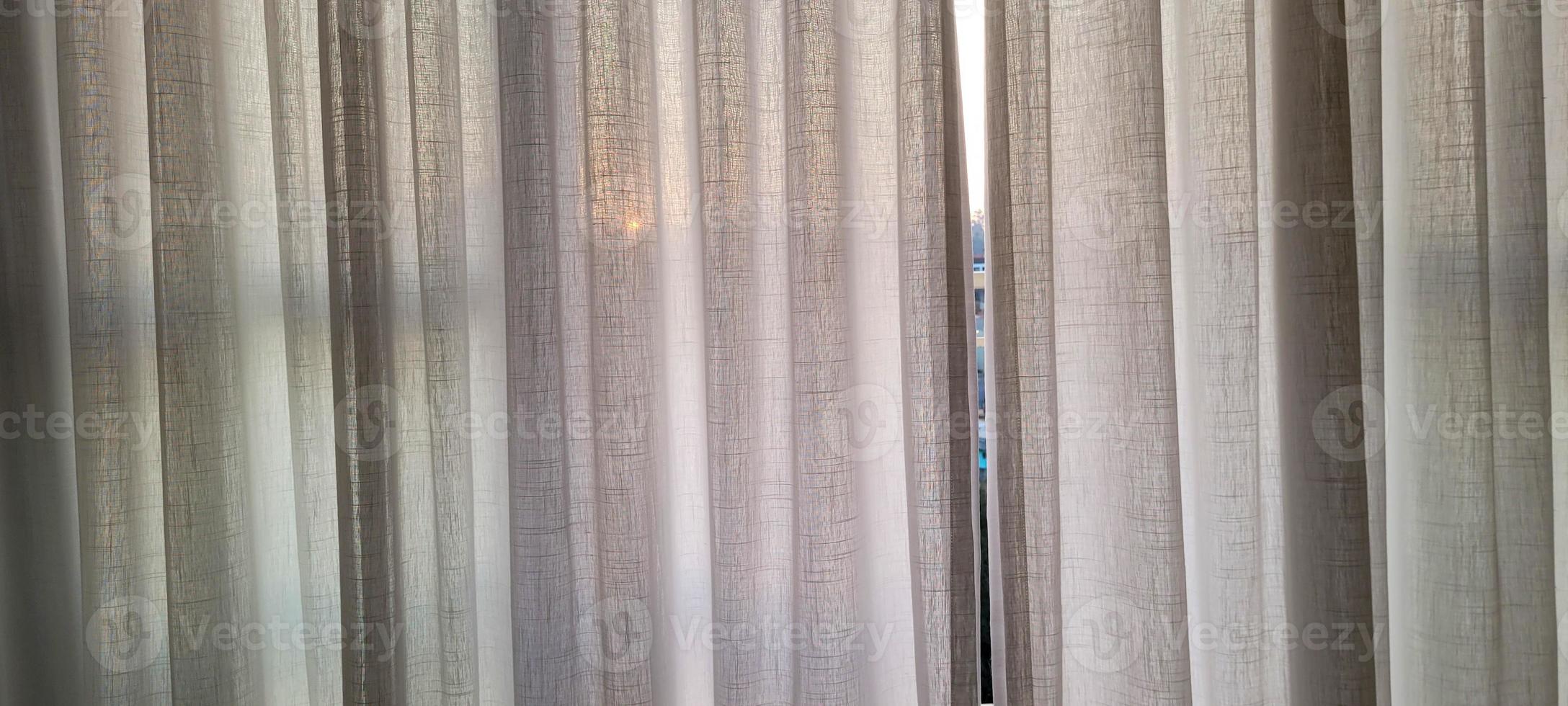 white linen curtain in apartment with sunset view in Brazil photo