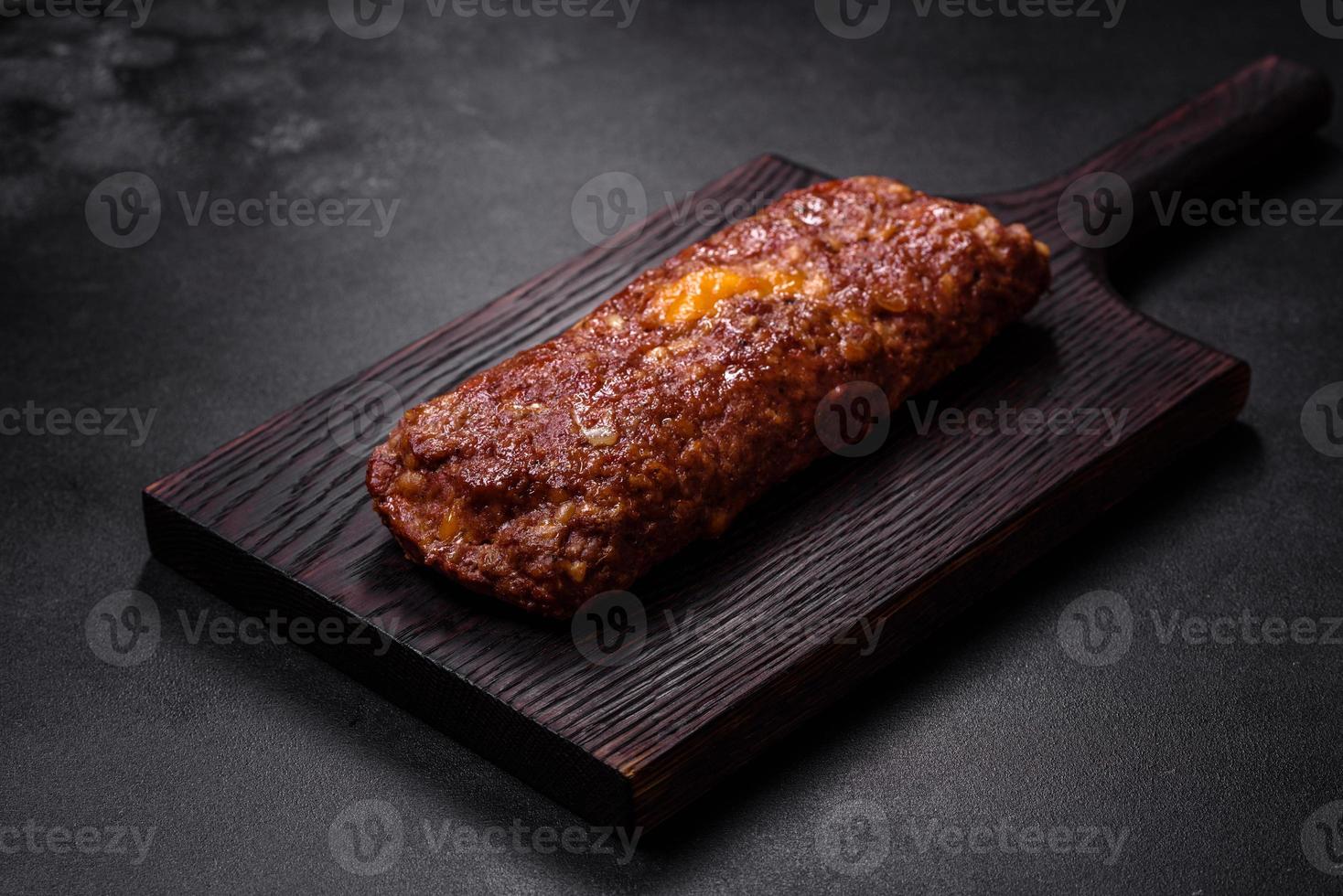 Delicious fresh ground beef meat roll with cheese, tomatoes and sweet peppers photo