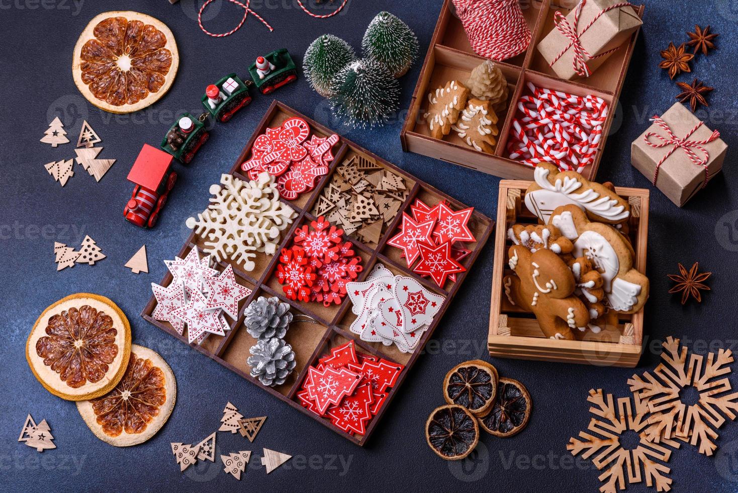 Christmas tree wooden toys in white and red colors, gingerbread and dried lemon and grapefruit slices photo