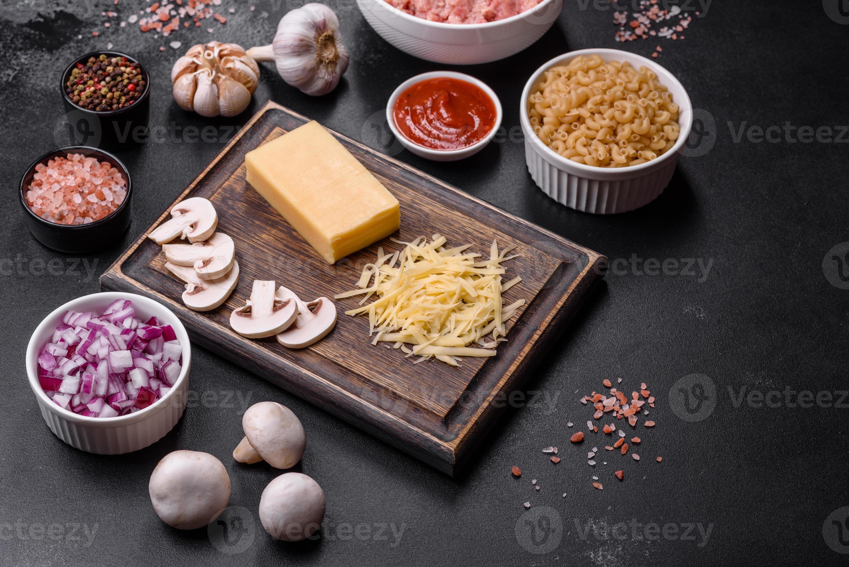Raw pasta, mushrooms, onions, mince, spices and herbs to make a