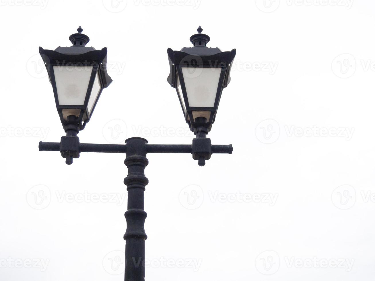 A beautiful street lamp on a background of a gray sky. photo