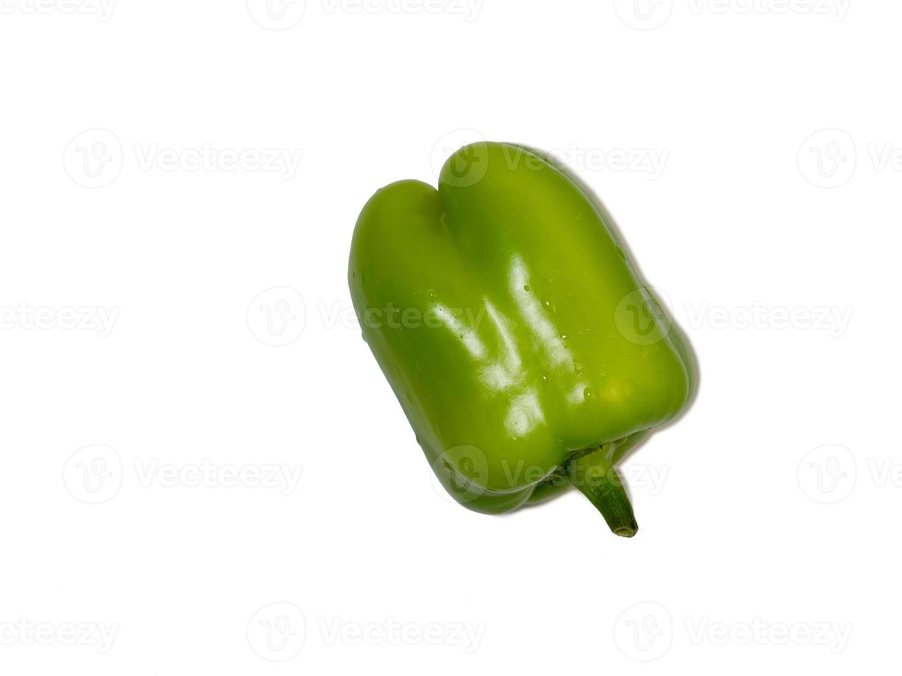 Dolma pepper on a white background. A juicy beautiful vegetable. Green sweet pepper in water droplets. photo