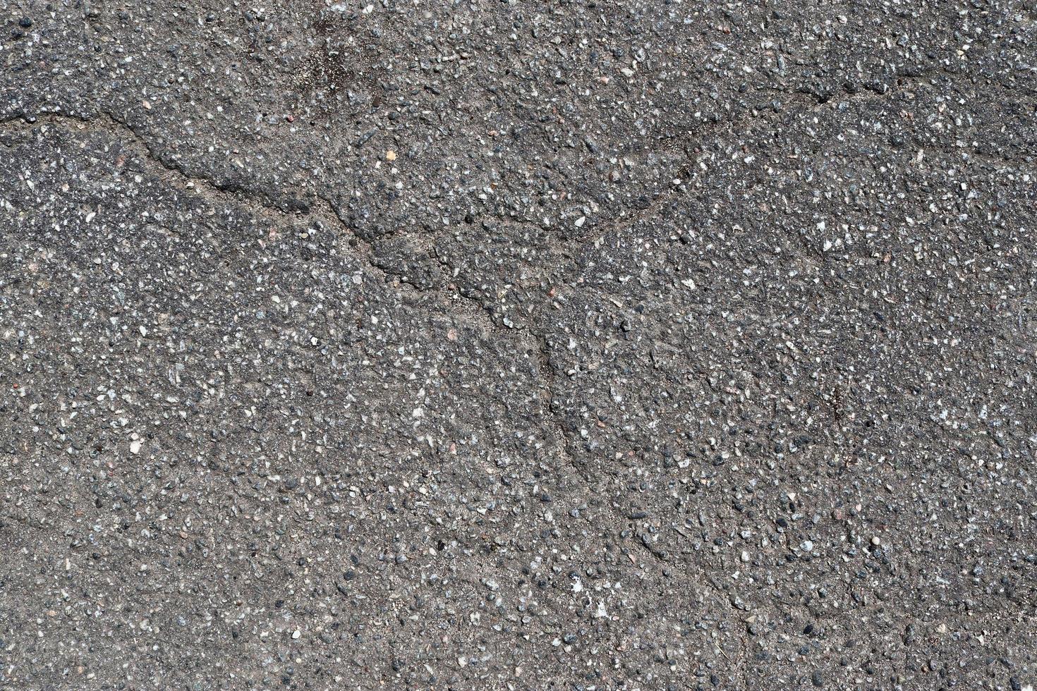 Detailed view on asphalt surfaces of different streets and roads with cracks photo