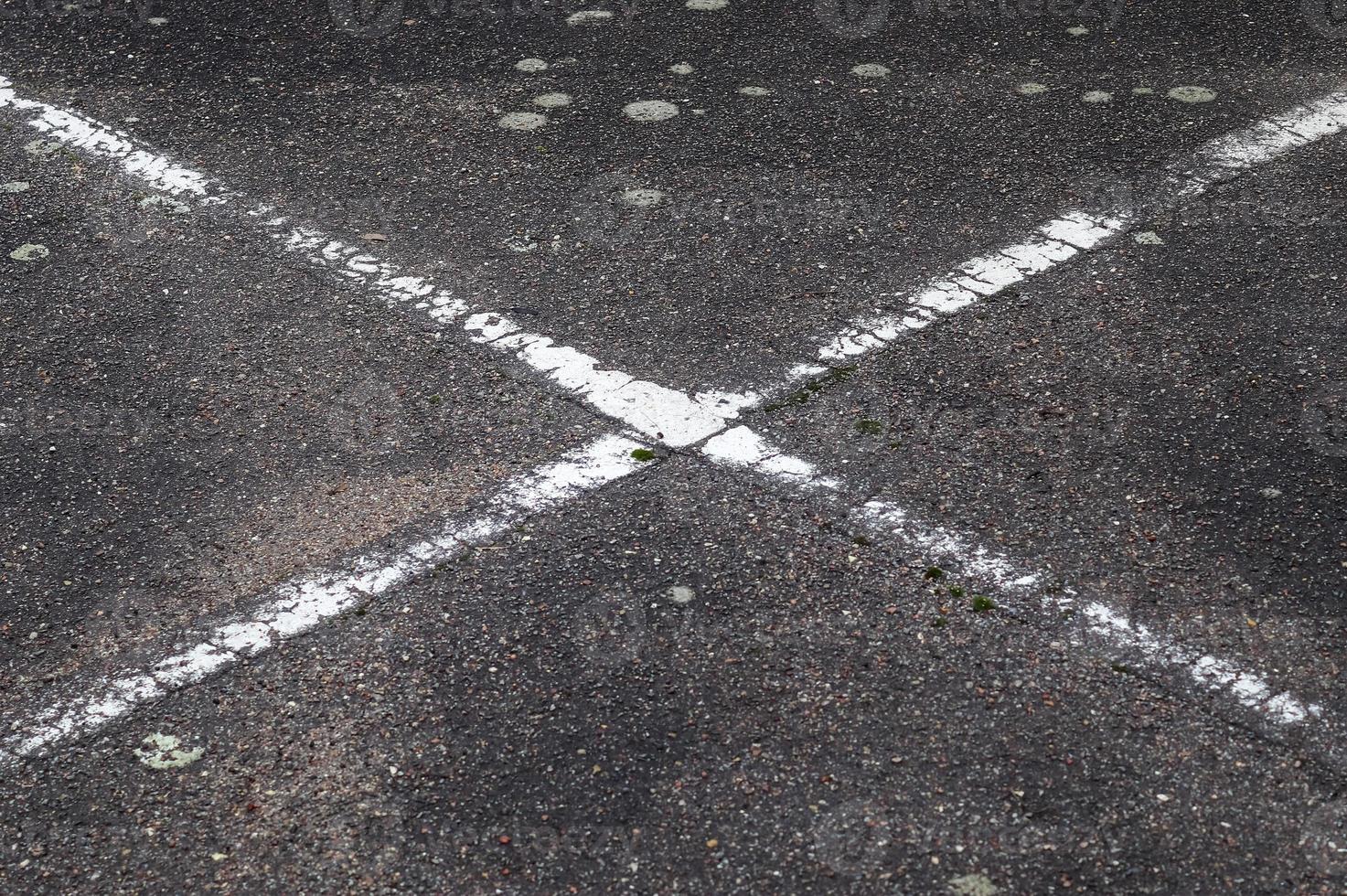 Detailed view on asphalt surfaces of different streets and roads with cracks photo