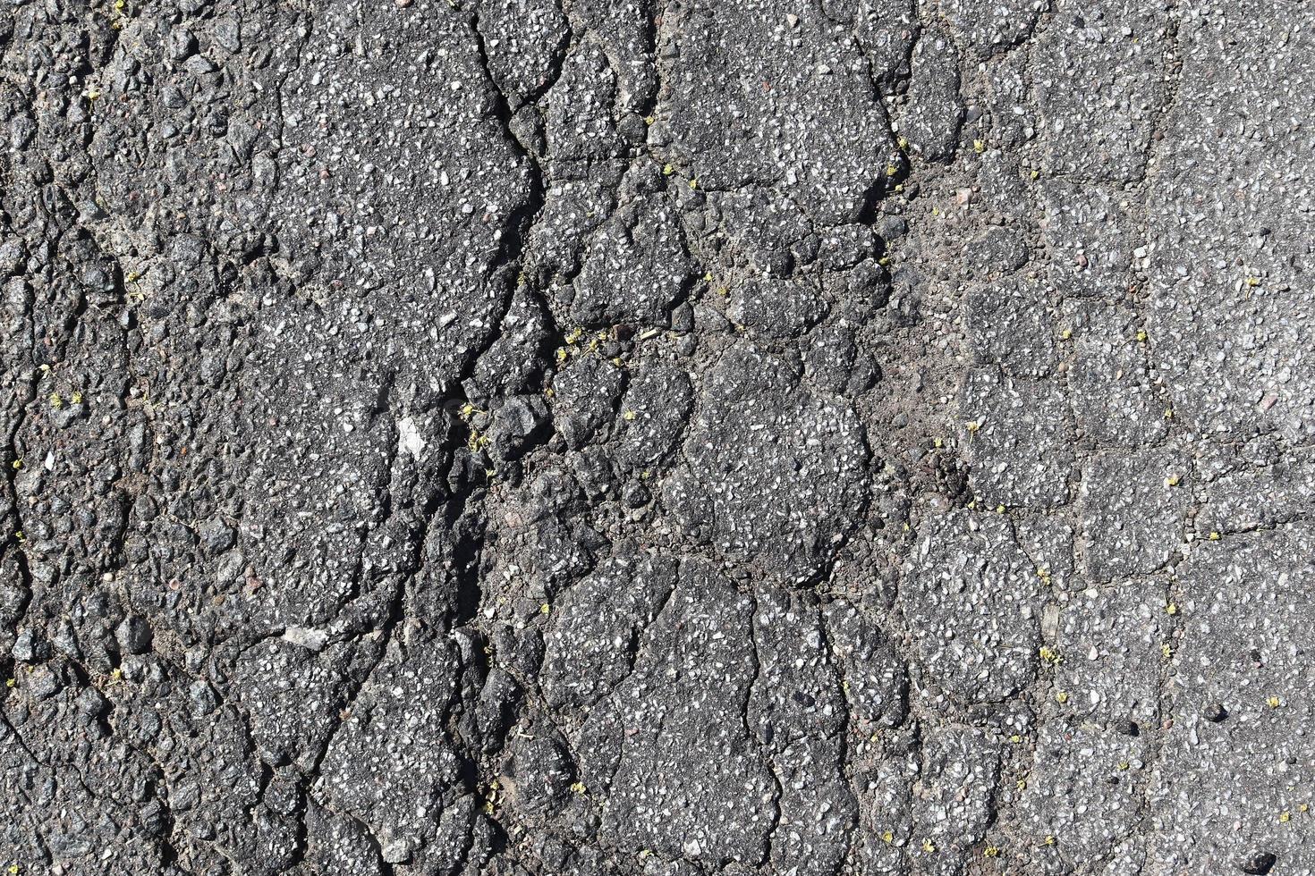 Detailed view on asphalt surfaces of different streets and roads with cracks photo