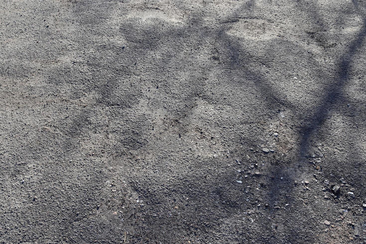 Detailed view on asphalt surfaces of different streets and roads with cracks photo